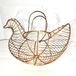 Vintage egg collecting basket shaped like a chicken or duck, copper colored wire